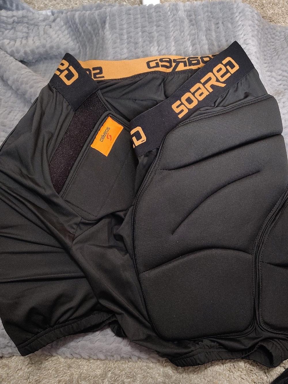 Soared Padded Black Protective Shorts with Orange Logo